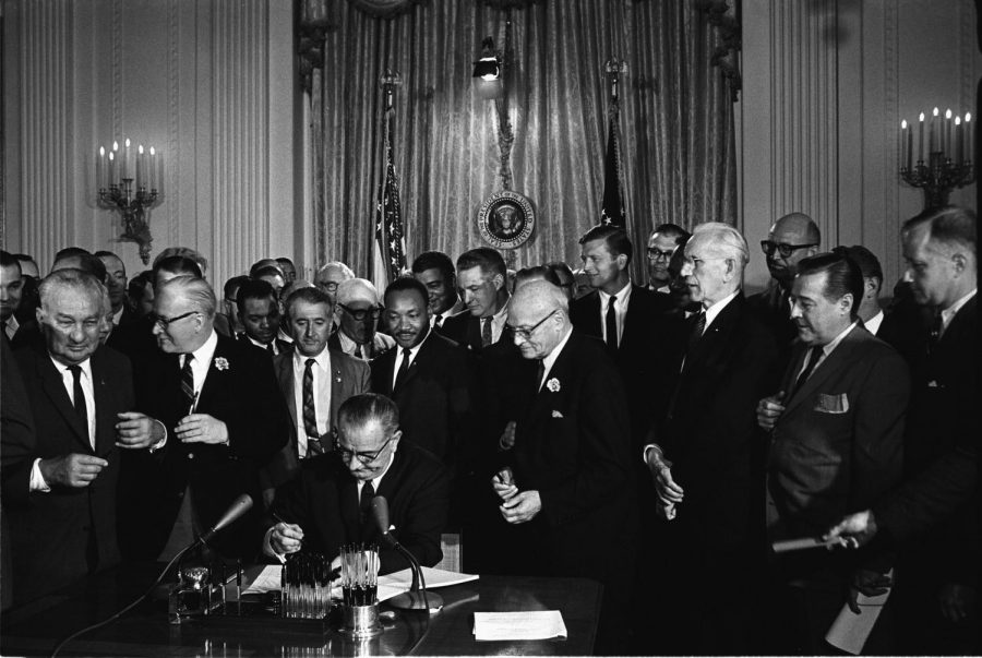 President+Lyndon+B.+Johnson+signing+the+Civil+Rights+Act+of+1964%2C+Dr.+Martin+Luther+King+Jr.+standing+directly+behind+the+President.