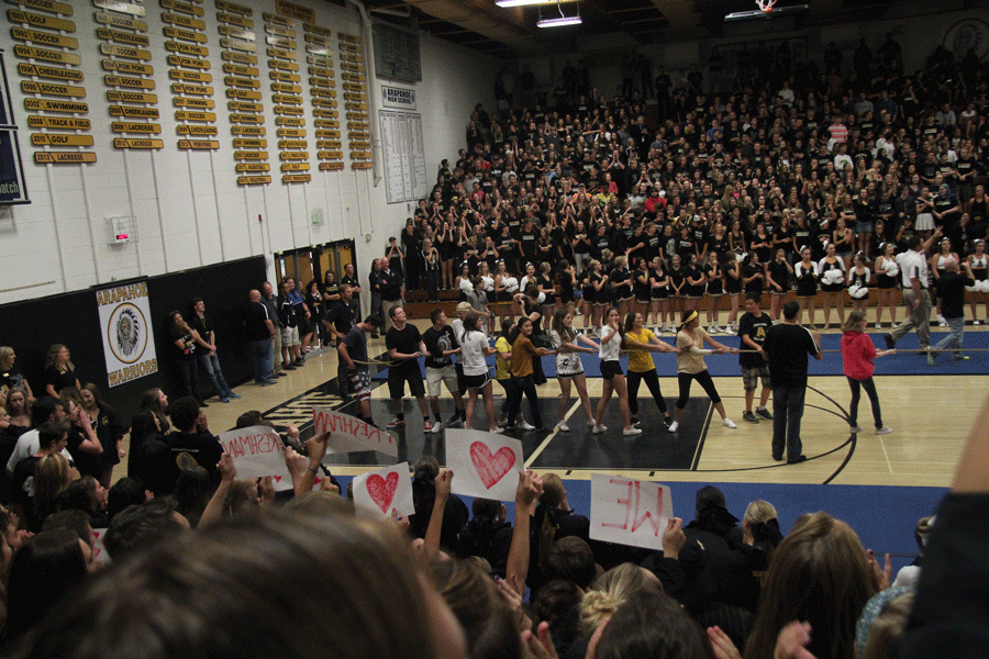 Surrounded by an ecstatic crowd, brave freshmen face off in tug-of-war against the juniors.