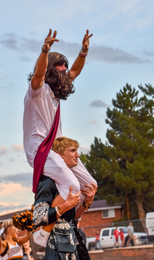 Dressed as Moses, Ryan Grubb, 12, sits on the shoulders of Joshua Chase Reitsema, 12. Every year, a senior wore a Moses costume to lead the student body in cheers at football games.